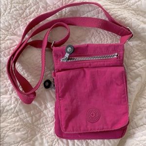 Kipling extra small crossbody purse pink/ purple.